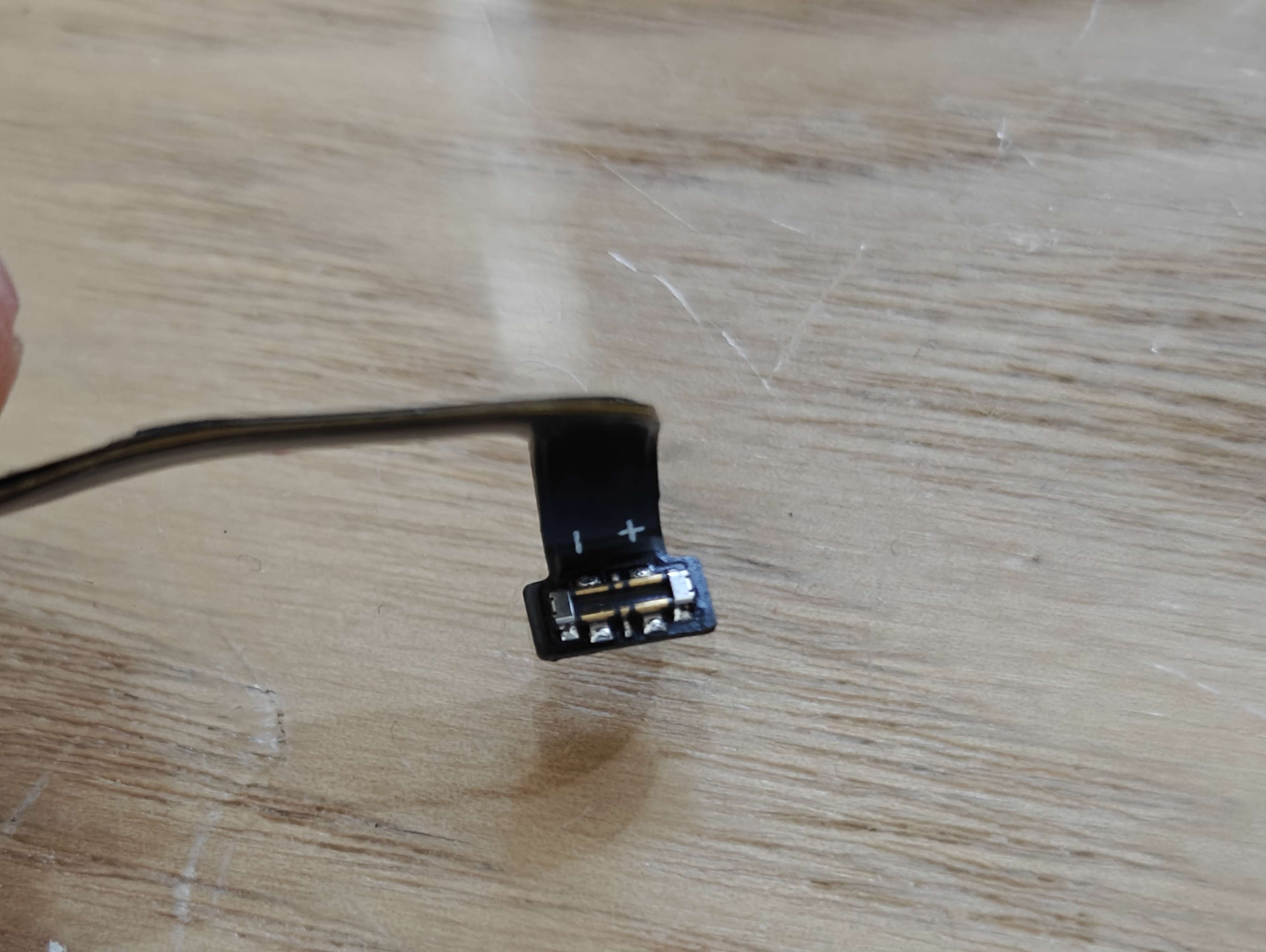 Motherboard connector on speaker cable (note the +/- indicators)